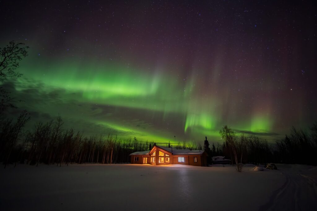 Northern lights dance over Face The Outdoors Private viewing lodge 100 miles from Fairbanks.