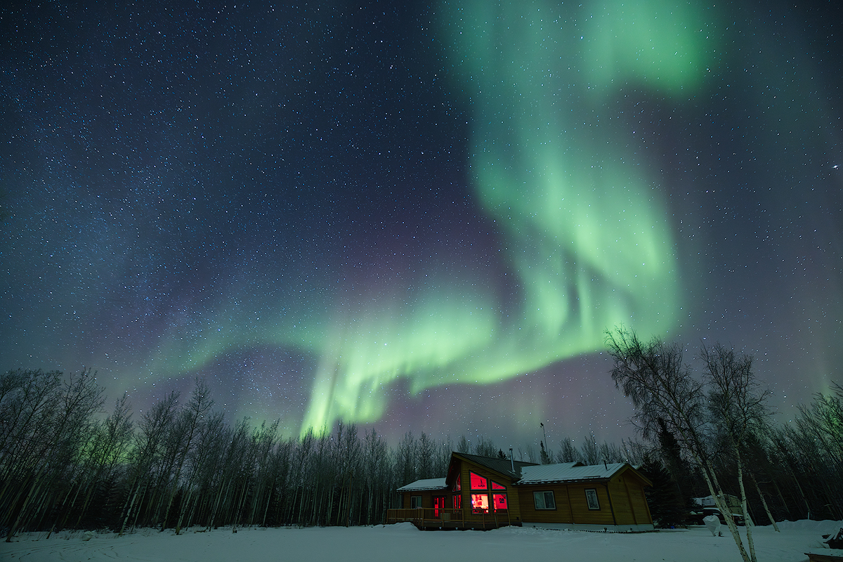 Northern lights aurora over private lodge in Fairbanks Alaska