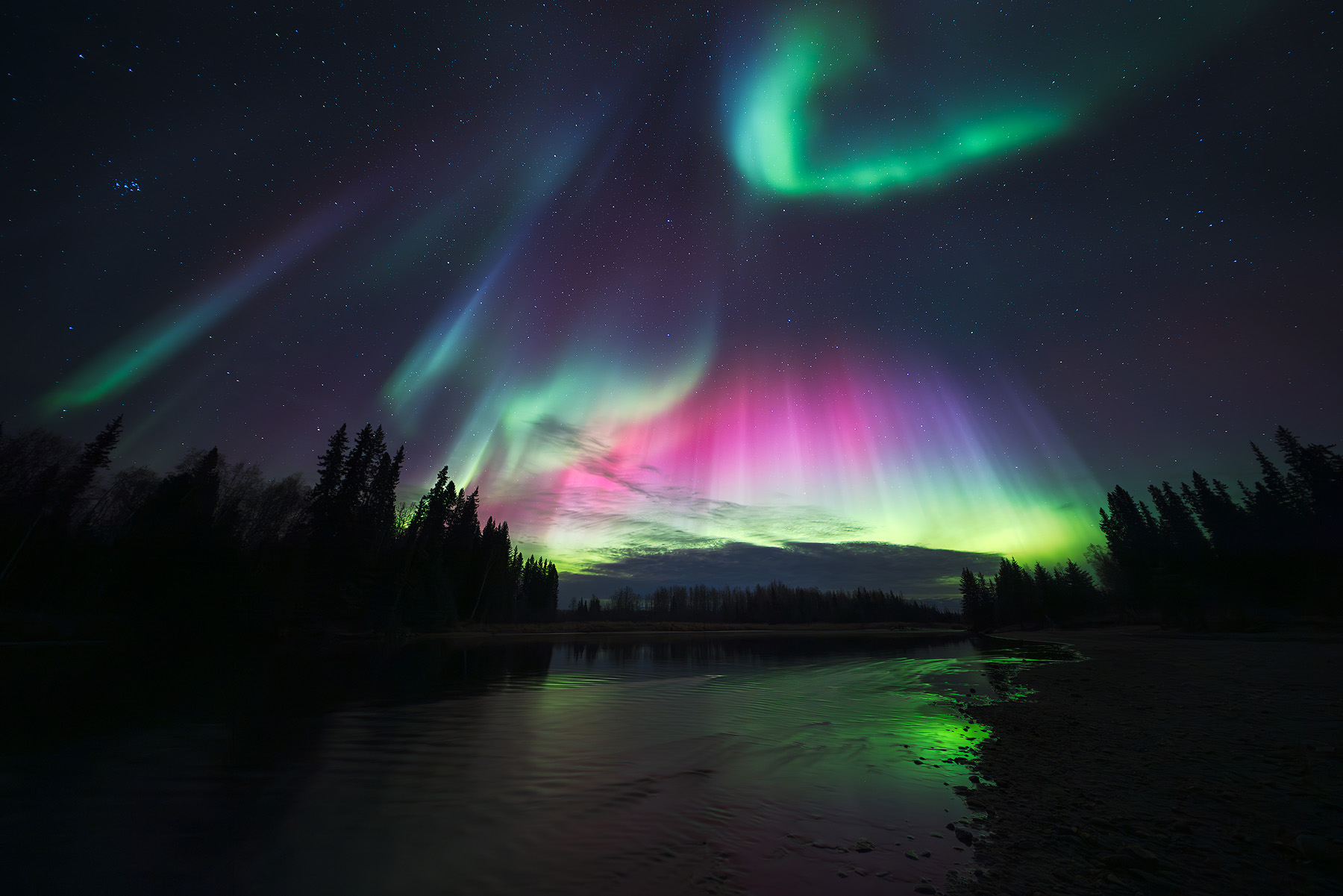 Fall equinox is a great time to see aurora borealis with purple and green northern lights over Alaskan landscape