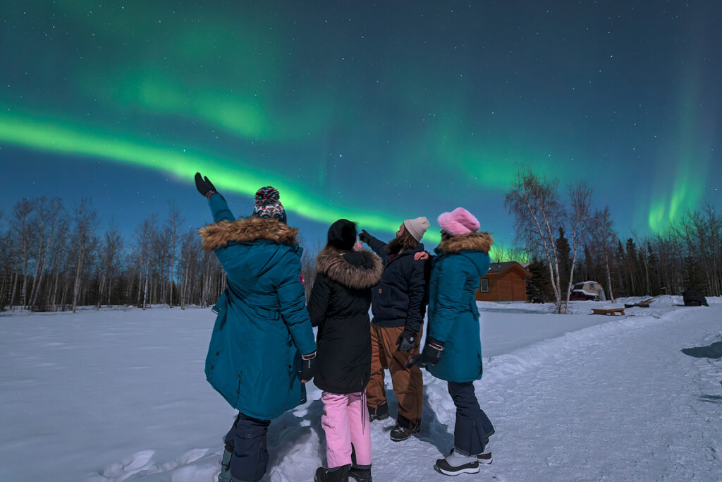 Alaska aurora viewing gear in action – properly dressed viewers watching northern lights near Fairbanks