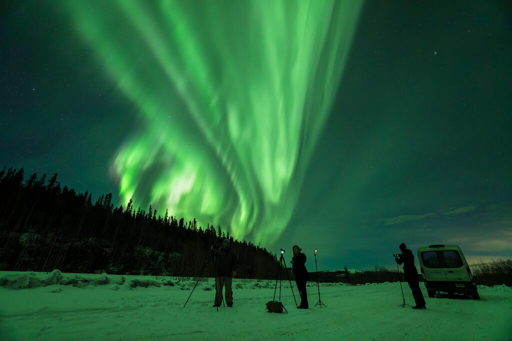 Northern lights tours chasing the northern lights near Fairbanks with small group van relocating to find clear skies for aurora viewing