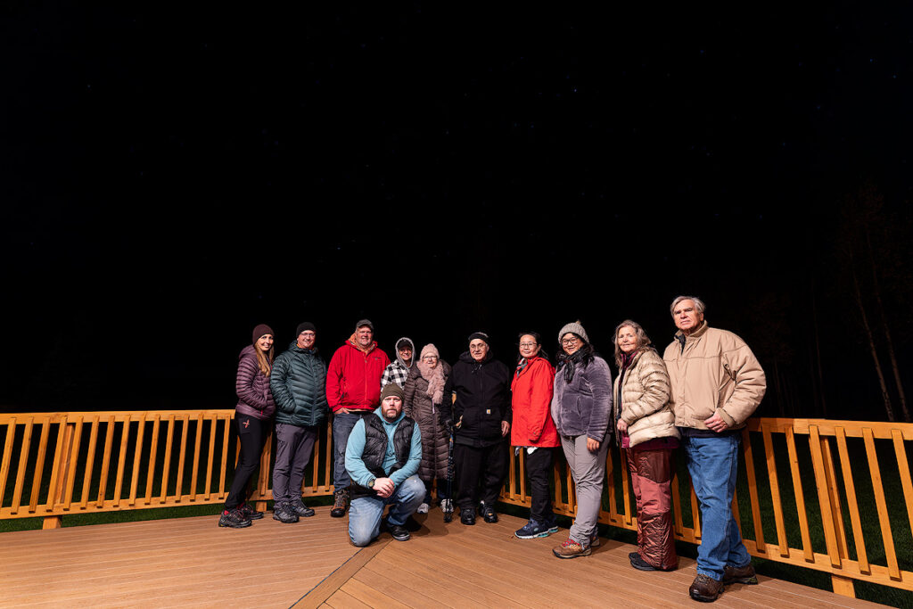 Michael Schultz Face The Outdoors owner and native Alaskan aurora guide with guests during northern lights tour in Fairbanks Alaska