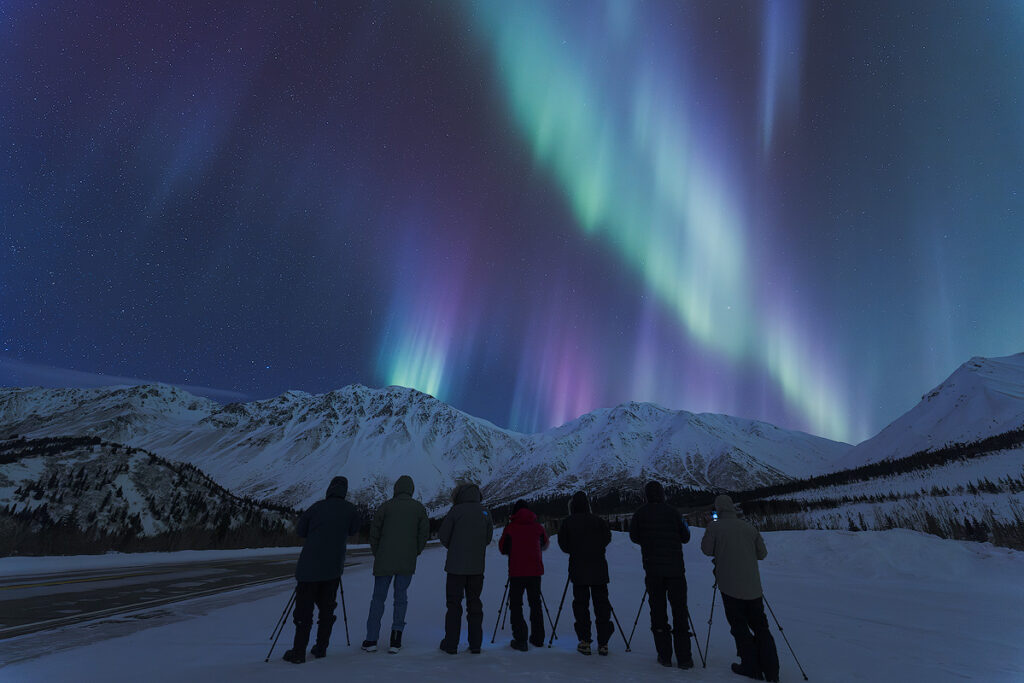  Blue and purple aurora fringe at the base of green curtains in Fairbanks — ionized nitrogen below 100 kilometres produces the blue-violet light visible during high solar activity and large geomagnetic storms