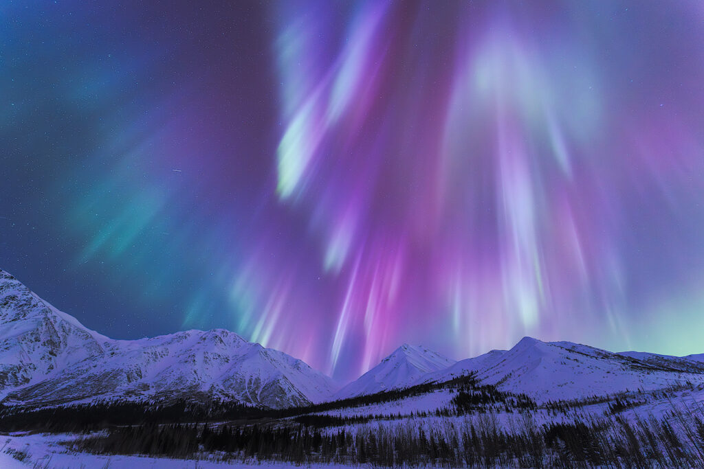 Colors of the northern lights over Fairbanks Alaska — aurora borealis showing green from oxygen, red from high-altitude oxygen, and violet from nitrogen at each atmospheric layer 