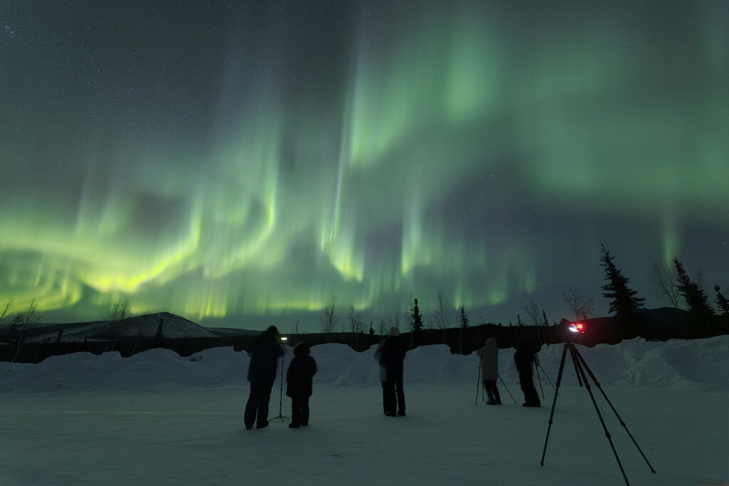 Dark adaptation aurora viewing at Face The Outdoors Fairbanks — guests waiting for the northern lights display that starts after midnight during active aurora season
